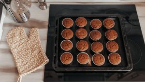 Chocolate muffins bakery. Brownie cupcakes on the baking pan. Baking at home, home bakery.