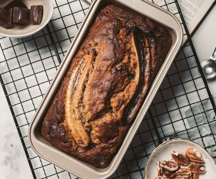 Flat lay image of a banana bread on a baking cooling rack